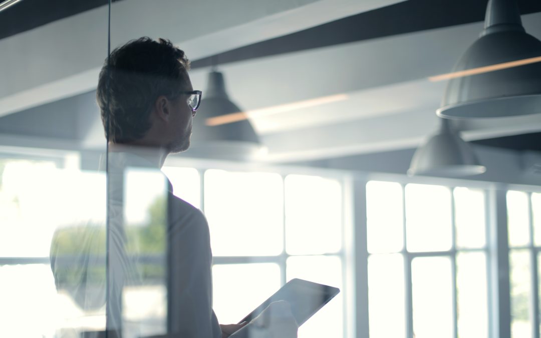 Man looking out window